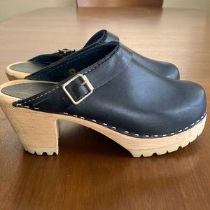 Black “Lotta von Stockholm” wooden clogs with buckle detail. Size 38/8